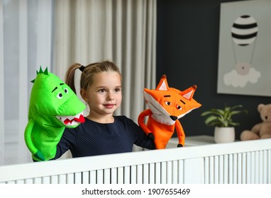 Cute Little Girl Performing Puppet Show At Home