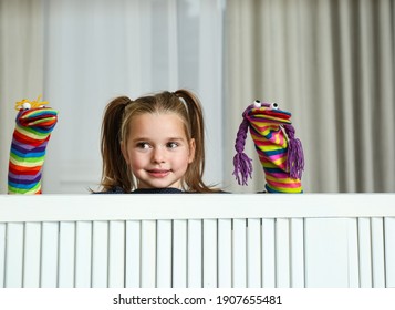 Cute Little Girl Performing Puppet Show At Home