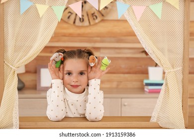 Cute Little Girl Performing Puppet Show At Home