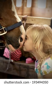 Cute Little Girl Petting The Horse 