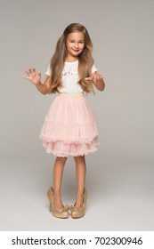 Cute Little Girl In Pink Tulle Skirt And Too Big Shoes