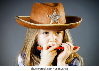 Cute Little Girl Playing Harmonica, Music Concept