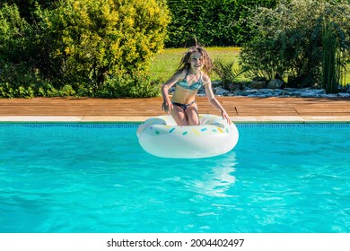 cute little girl playing in the pool - Powered by Shutterstock