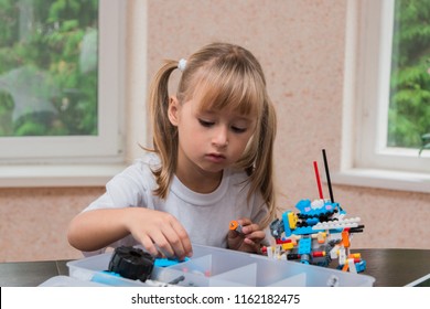 Cute Little Girl Is Playing With Robot At Home And Programming It On Tablet. STEM Education. 