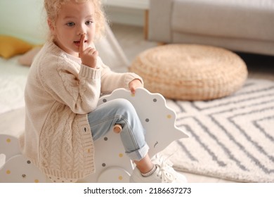 Cute Little Girl Playing With Rocking Horse At Home