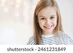 Cute little girl portrait at home. Funny child smiling and looking at camera