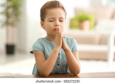 Cute Little Girl Praying At Home