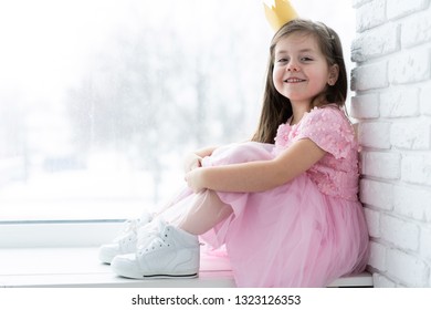 Cute Little Girl In A Princess Costume. Pretty Child Preparing For A Costume Party. Beautiful Queen In Gold Crown