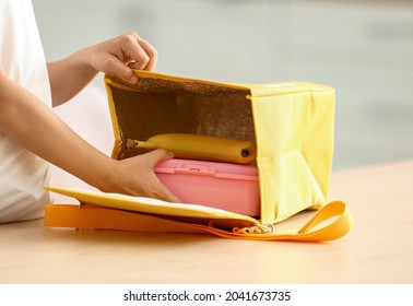 Cute Little Girl Putting Her Lunch In Bag