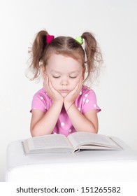 Cute Little Girl Is Reading A Book, Isolated Over White