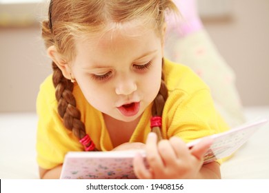 Cute Little Girl Reading A Book