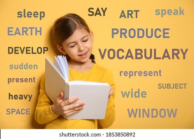 Cute little girl reading vocabulary surrounded by different words in English on yellow background