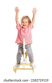 Cute little girl with rocking horse on white background