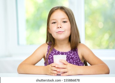 Cute Little Girl Is Showing Milk Moustache