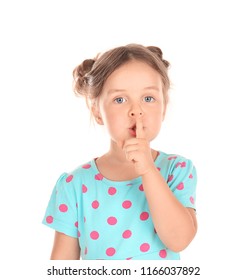 Cute little girl showing silence gesture on white background
