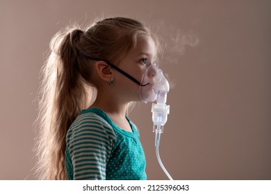 cute little girl is sick. lung disease, covid-19. child does the inhalation procedure with nebulizer of the respiratory tract. treating child for cough. compression inhaler. health concept. isolated