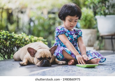 Cute Little Girl Sit With Dog Playing Calculator Outdoor.