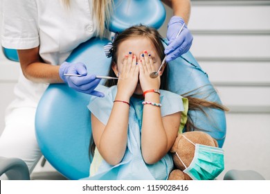 Cute little girl sitting on dental chair and having dental treatment. - Powered by Shutterstock