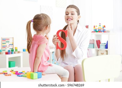Cute little girl at speech therapist office - Shutterstock ID 596748269
