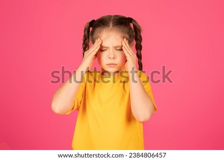 Cute Little Girl Suffering Headache, Upset Preteen Female Child Touching Head With Hands, Feeling Acute Migraine, Depressed Kid Standing Isolated Over Pink Studio Background, Copy Space ストックフォト © 