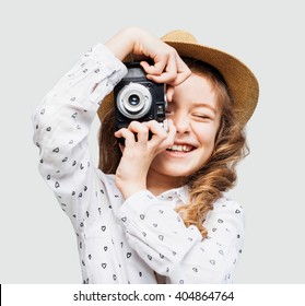 Cute little girl takes picture with vintage camera - Powered by Shutterstock