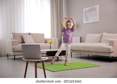 Cute Little Girl Taking Online Dance Class At Home