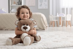 Cute Little Girl With Teddy Bear On Floor At Home