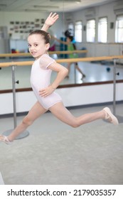 Cute Little Girl Toddler Ballerina In Pale Pink Tutu And Ballet Shoes Practicing Dance Jump