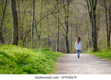 Cute Little Girl Walking Away On A Forest Path