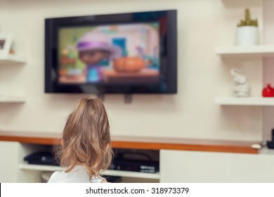 Cute Little Girl Watching Tv At Home. 