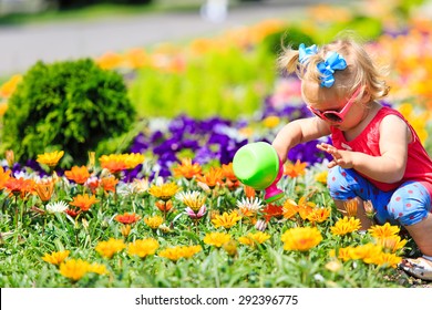 Cute Little Girl Watering Flowers In Summer, Kids Gardening