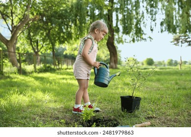 Cute little girl watering tree in garden - Powered by Shutterstock