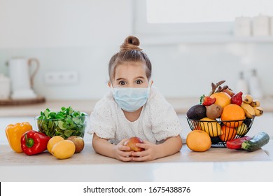 Cute little girl wearing surgical face mask respirator fighting against Corona virus covid19 with fruit and vegetables, looking surprised, scared, surounded by vegetables, fruit and nutrition food - Powered by Shutterstock