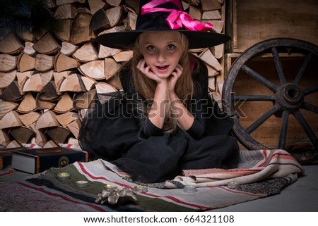 Cute little girl witch in black dress