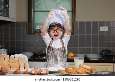 Cute Little Happiness Boy Preparing The Dough And Face With Sloppy Dough. People Lifestyles And Family. 
Baking Christmas Cake And Cook Concept
