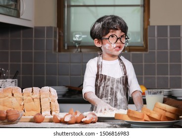 Cute Little Happiness Boy Preparing The Dough And Interested While Face With Sloppy Dough. People Lifestyles And Family. 
Baking Christmas Cake And Cook Concept