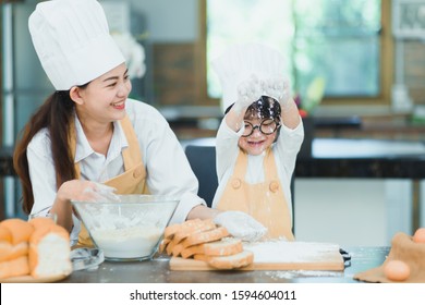 Cute Little Happiness Boy Preparing The Dough And Face With Sloppy Dough. People Lifestyles And Family. Baking Christmas Cake And Cook Concept.