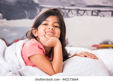 Cute Little Indian Girl Sleeping Over White Bed Sheet And Pillow. 