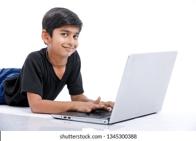 Cute Little Indian/Asian Boy Studying Or Playing Game With Laptop Computer