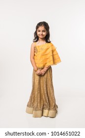 Cute Little Indian/Asian Girl Child In Traditional Wear Standing Isolated Over White Background