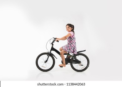 Cute Little Indian/asian Girl Riding On Bicycle, Isolated Over White Background 