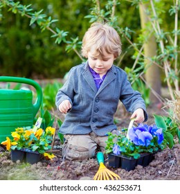 Cute Little Kid Boy Helping With Gardening In Spring Garden. Funny Child Planting Flowers. Family, Spring, Planting Concept.