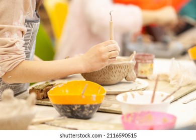 Cute little kid playing with modeling clay in pottery workshop, craft and clay art, child creative activities, education in Arts - Shutterstock ID 2116590515