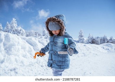 cute little kid walking alone in the middle of snowy mountain