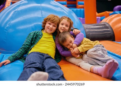 Cute little kids of different age playing on inflatable bounce house - Powered by Shutterstock