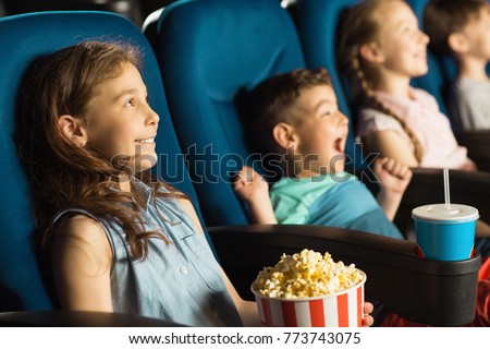 Cute little kids smiling joyfully watching a movie at the cinema entertainment childhood kids comedy cartoons family recreation leisure activity holidays positivity emotions concept 