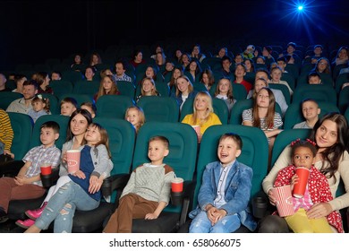 Cute Little Kids Smiling And Laughing While Watching A Cartoon At The Local Movie Theatre People Entertaining Excitement Expressive Funny Laughter Enjoyment Elementary Lifestyle Leisure Concept.