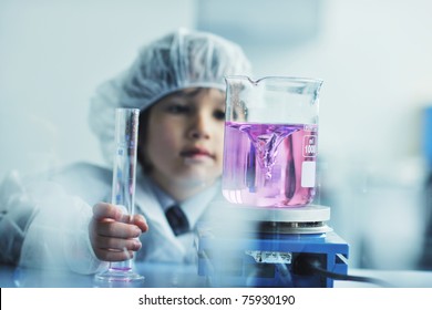 cute little male child have experiment with test tubes in bright modern lab
