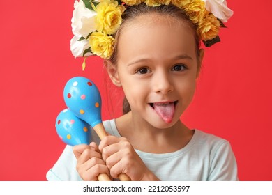 Cute Little Mexican Girl In Floral Wreath With Maracas On Red Background
