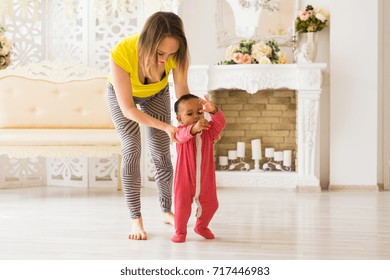 Cute Little Mixed Race Baby Learning To Walk, Mom Is Holding His Hands